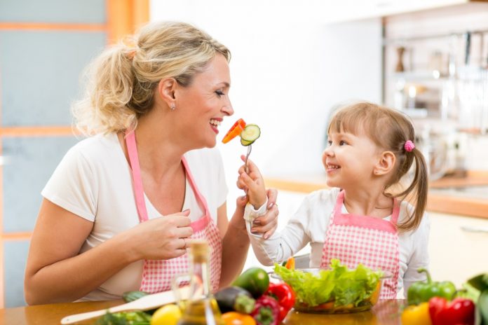 mom-daughter-eating-vegetables-Custom